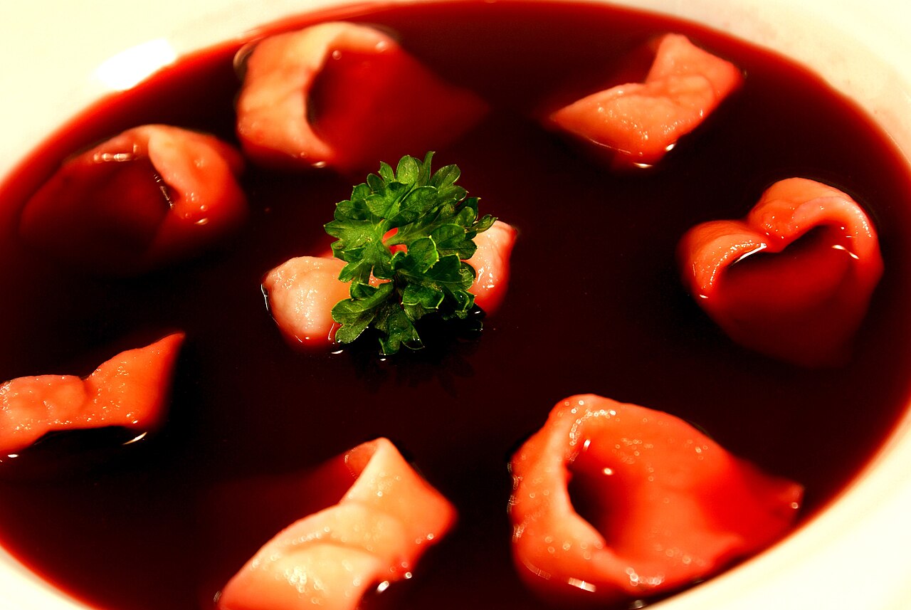 Clear red barszcz with uszka dumplings floating in it